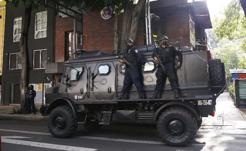 A police vehicle arrives to the place where an abandoned vehicle that is believed to have been used by gunmen in an attack against the chief of police was found, in Mexico City. (Photo by Marco Ugarte/AP Photo)